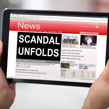 Hands Holding A Digital Table With A Screen Showing Unfolds Scandal News
